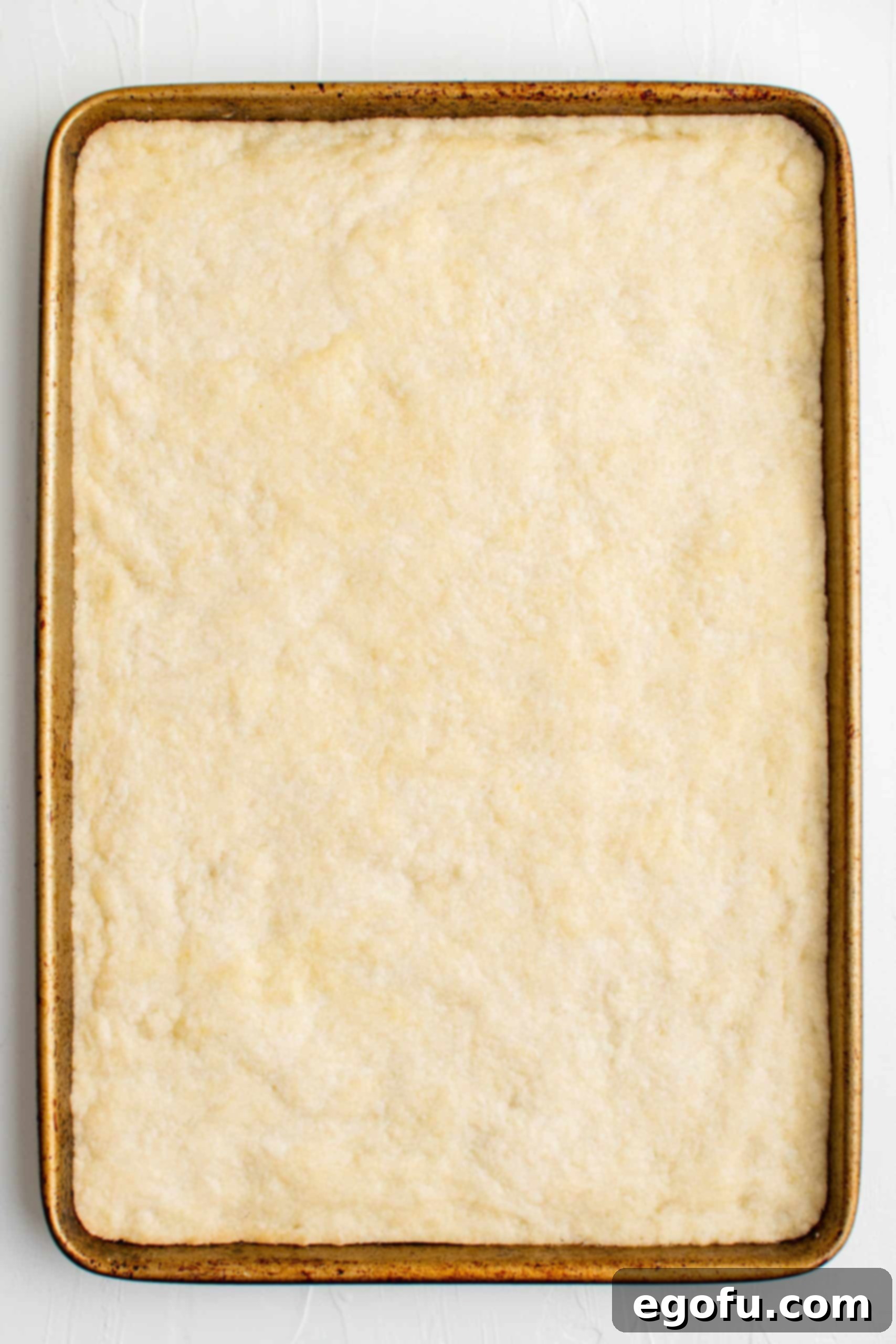 Golden Cherry Crumble Bars 9 Crust in pan after being baked.