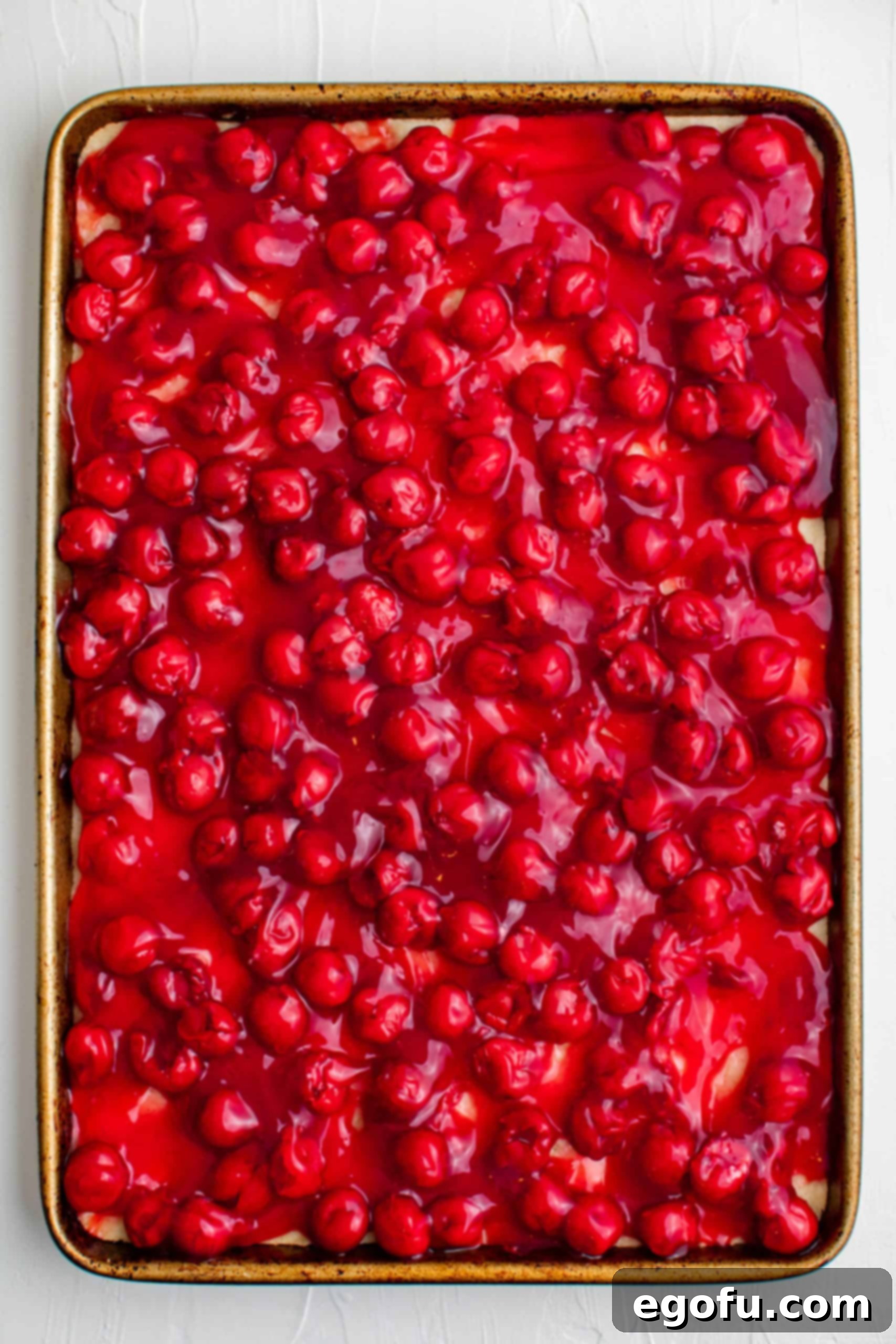 Golden Cherry Crumble Bars 10 Cherry pie filling covering the crust in the pan.