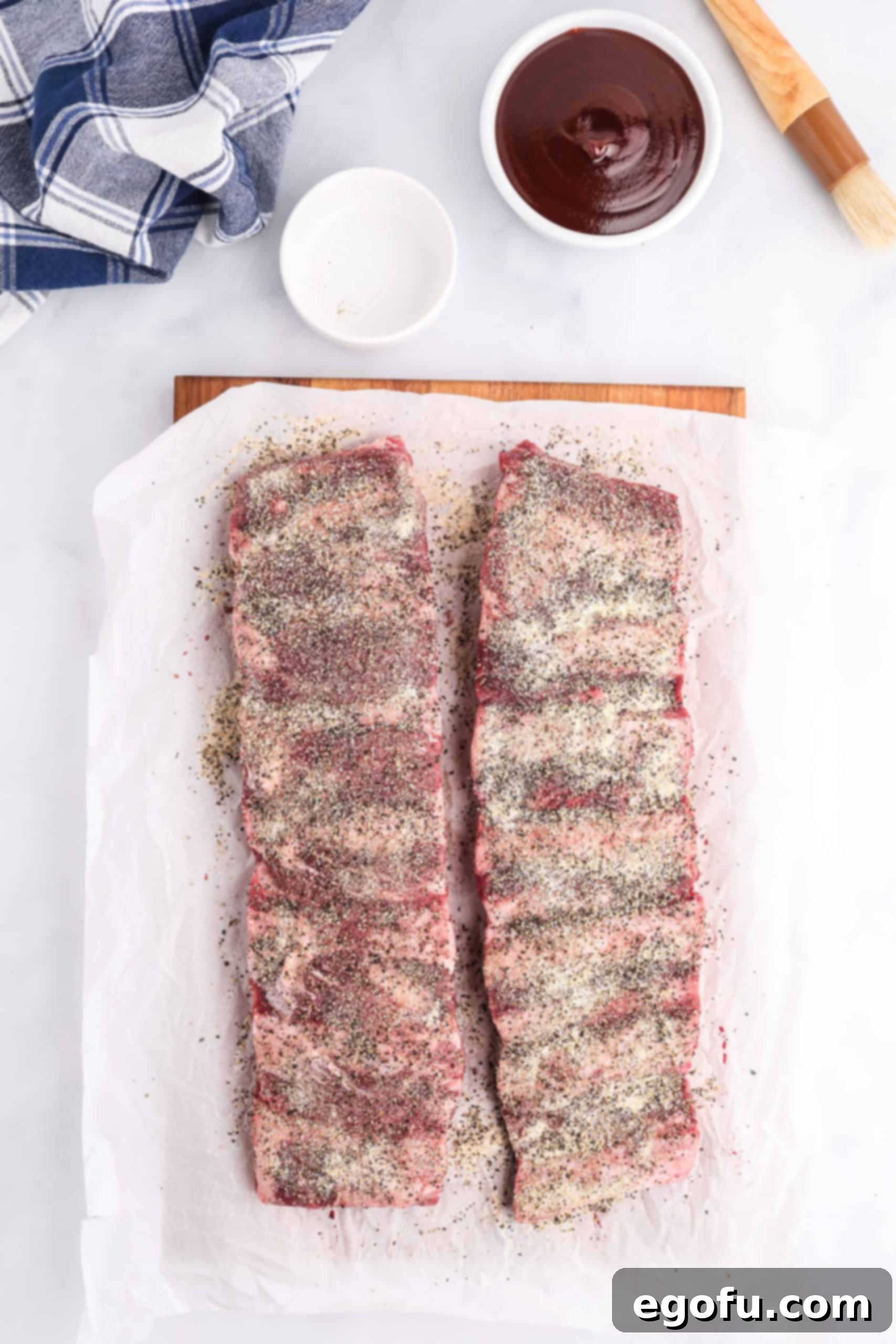 Slow-Smoked Beef Ribs 5 Ribs covered with dry ingredients.
