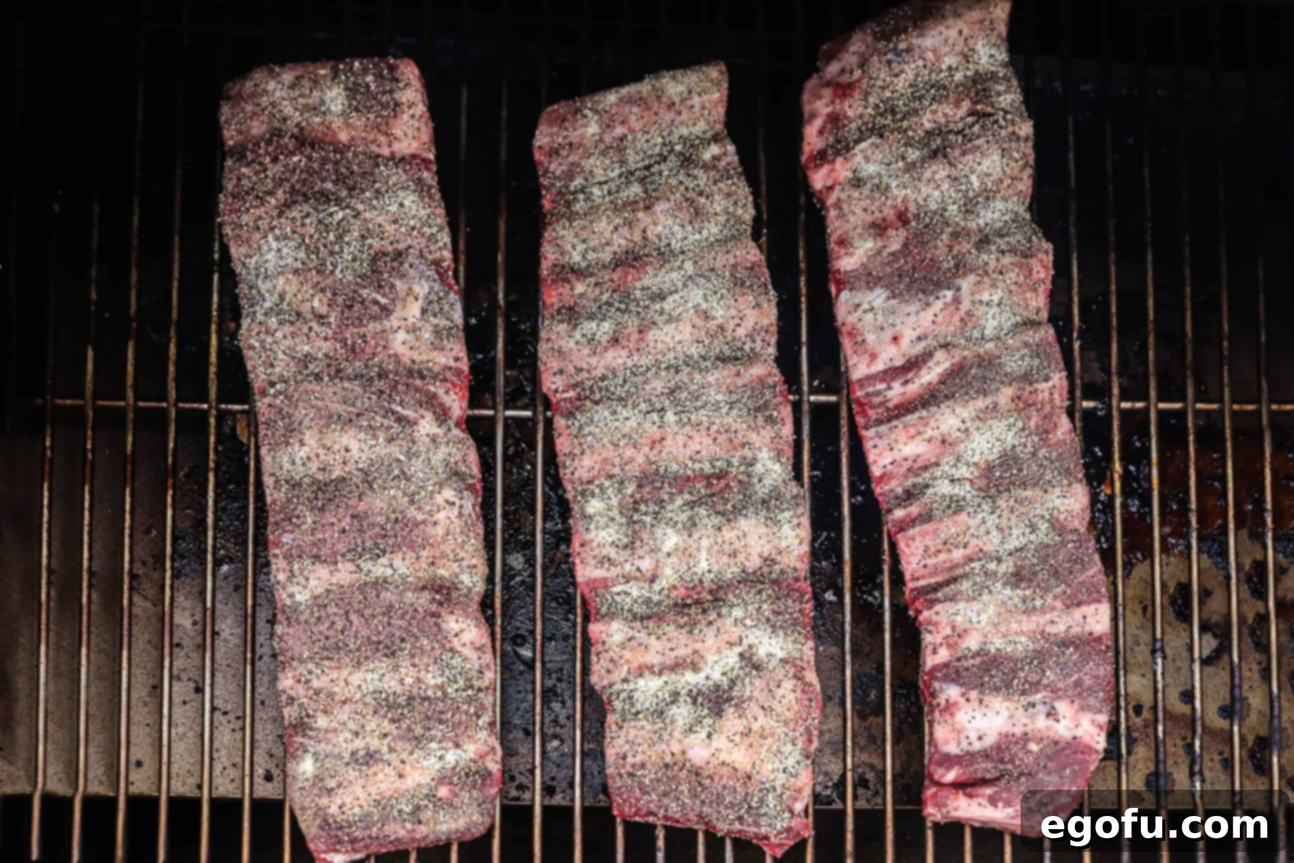 Slow-Smoked Beef Ribs 6 Ribs being placed on the smoker.