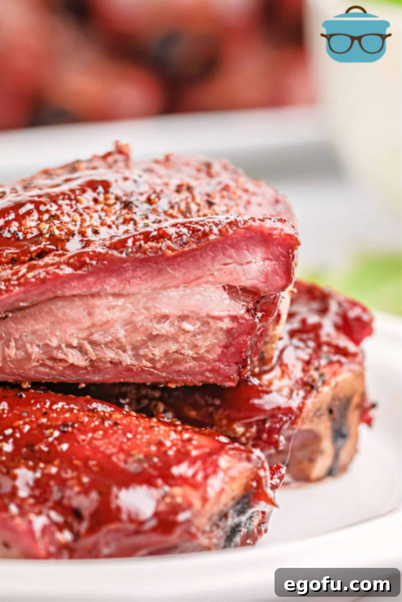 Slow-Smoked Beef Ribs 10 Close up of Ribs stacked on plate showing smoke ring.