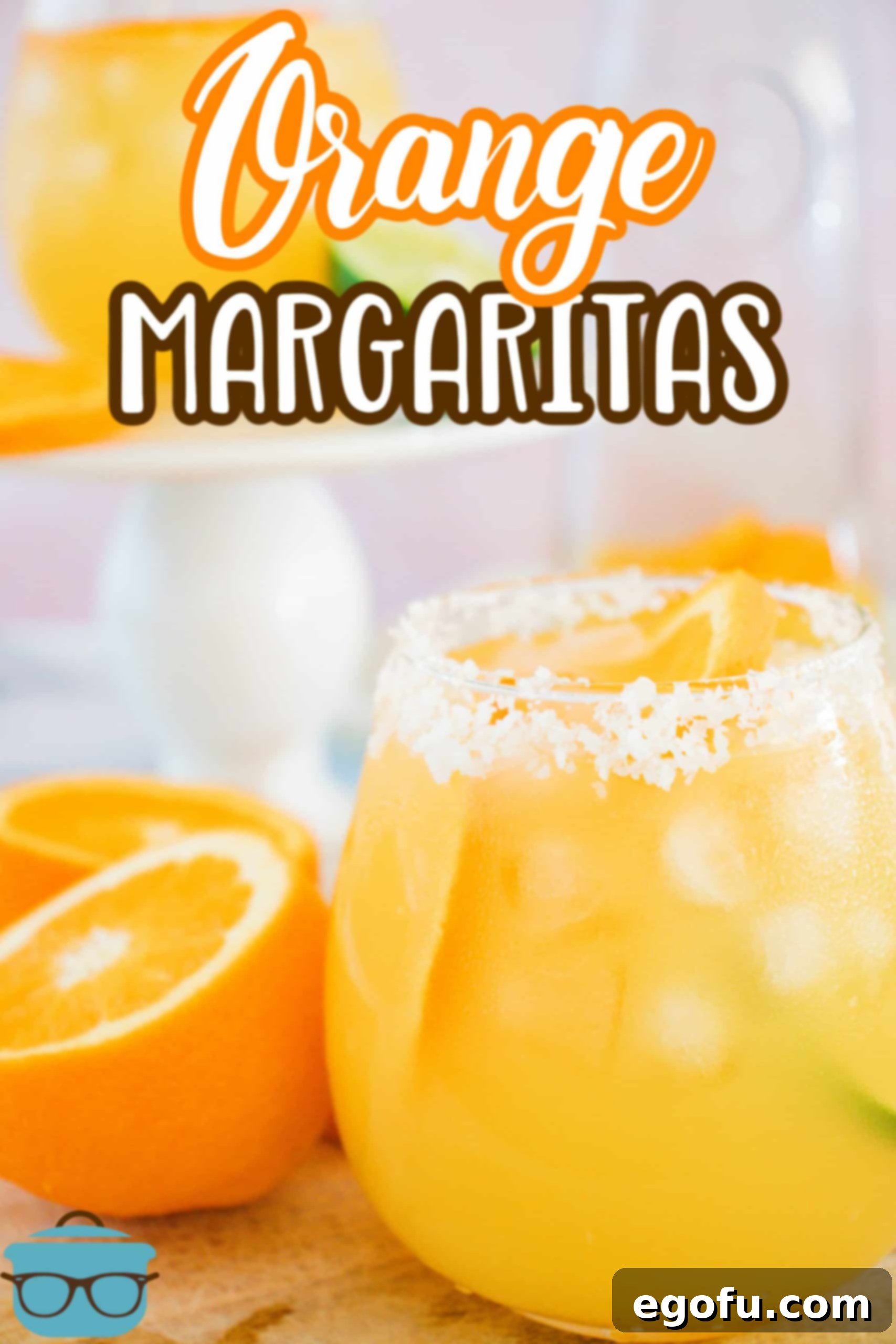 Garnished Orange Margaritas in glass with oranges around the outside Pinterest image.