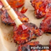 Close up of Homemade BBQ Sauce recipe basting chicken on pan
