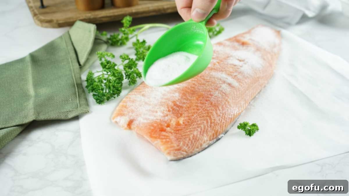 Salmon being sprinkled with salt