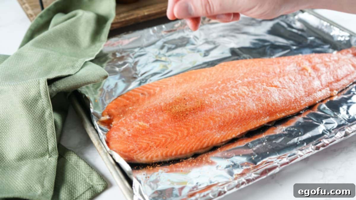 BBQ Rub being sprinkled over salmon filet