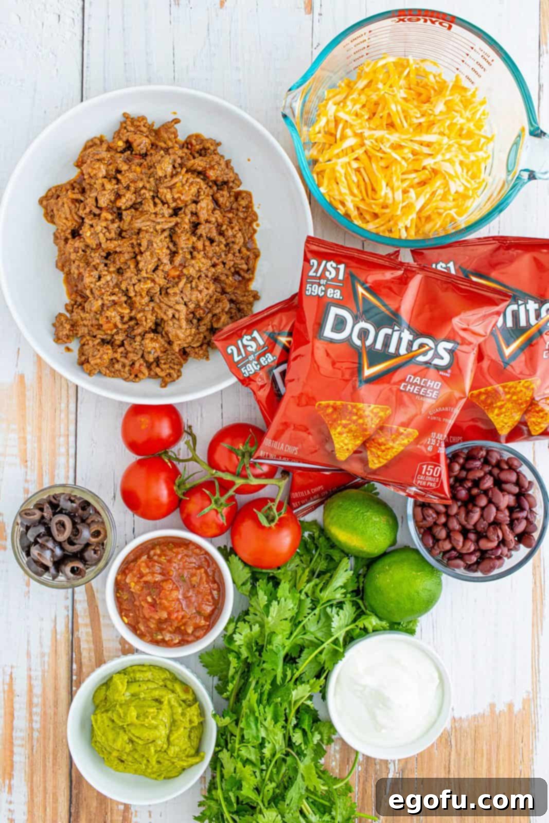Ingredients needed for Walking Tacos: Doritos, seasoned taco meat, black beans, Colby Jack cheese and an assortment of Favorite Taco Toppings