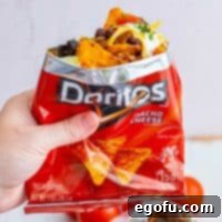 Hand holding up bag of Doritos Walking Tacos square image