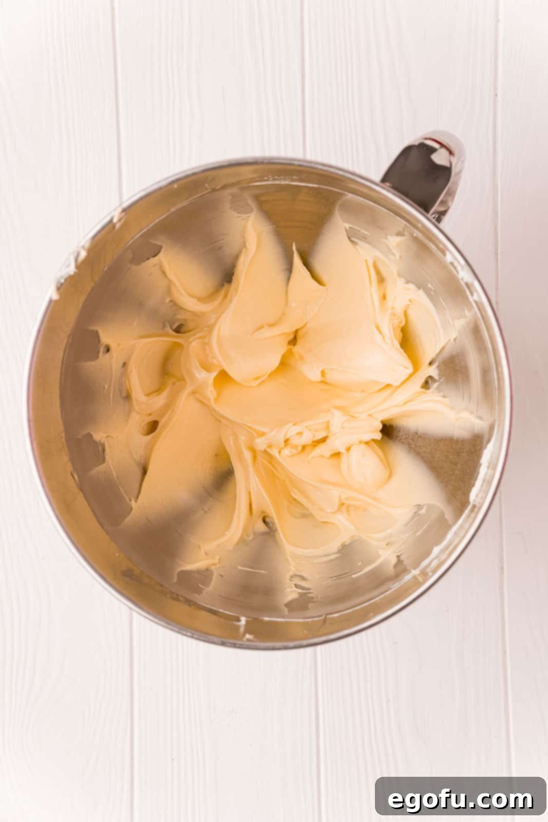 A smooth and creamy cream cheese mixture, perfectly blended in the bowl of a stand mixer, ready for the danish assembly.
