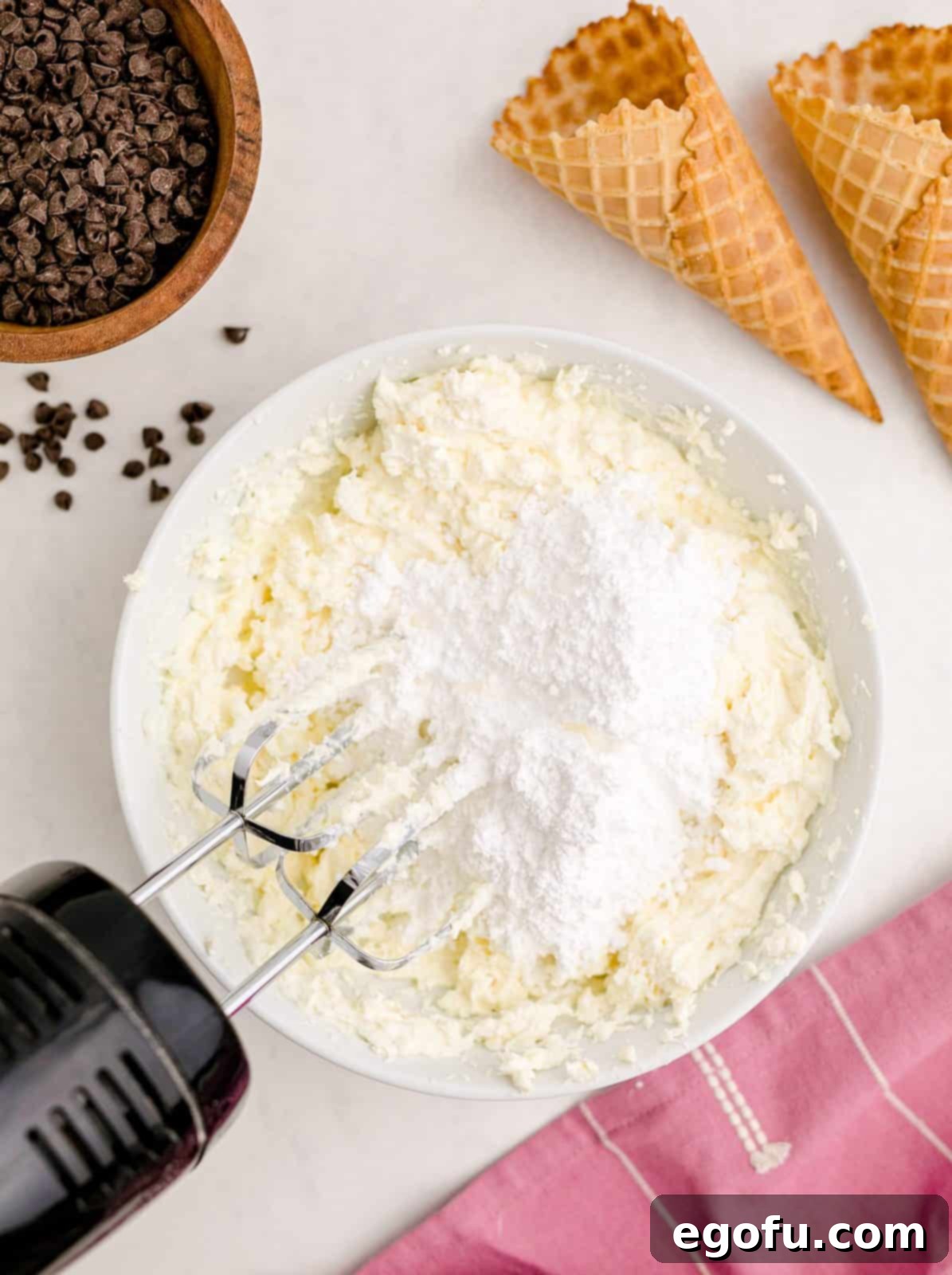 The smooth, beaten cheese mixture with powdered sugar added to the bowl, ready for the next step in creating the delicious Cannoli Dip.