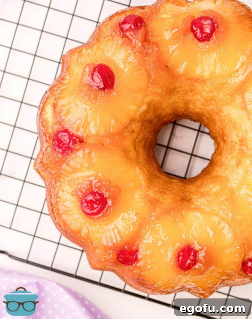 Sunshine Pineapple Bundt Cake 18 Overhead shot of a perfect Pineapple Upside Down Bundt Cake resting on a cooling rack, ready to be served.