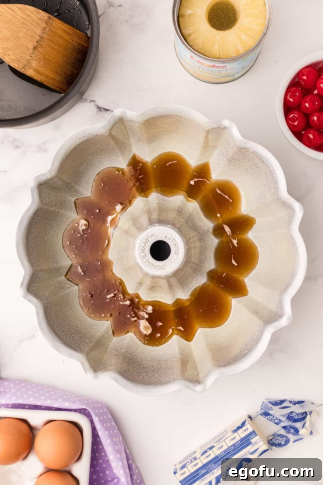 Sunshine Pineapple Bundt Cake 6 Melted brown sugar, butter, and pineapple juice mixture coating the bottom of a bundt pan.