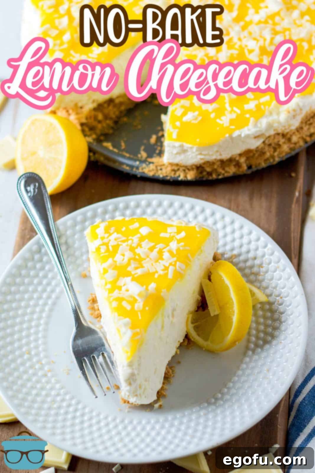 Pinterest image of overhead angled photo of slice of No-Bake Lemon White Chocolate Cheesecake on white plate with whole cheesecake in background.