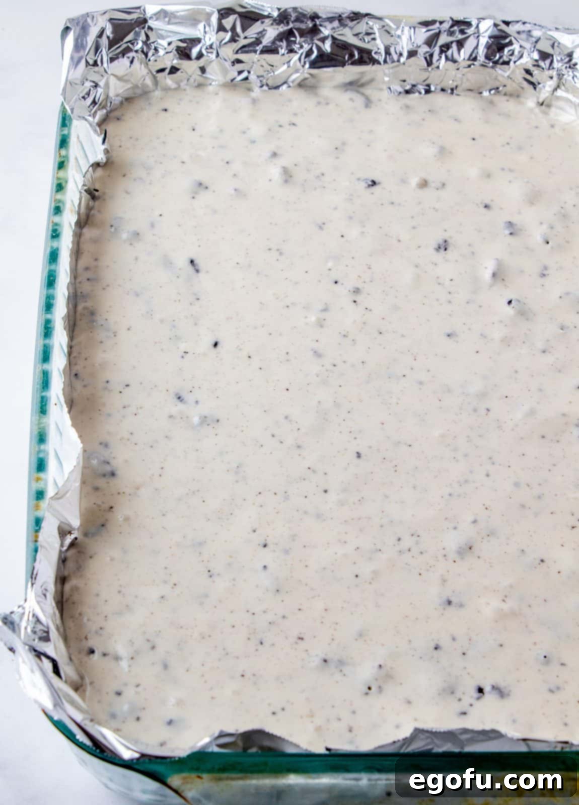 Cheesecake mixture poured into prepared pan over crust.