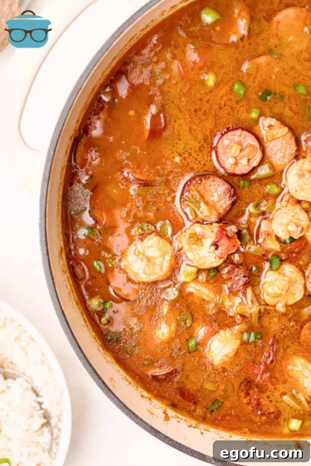 Overhead view of a dutch oven filled with rich Southern Shrimp Gumbo, showcasing shrimp, sausage, and vegetables.