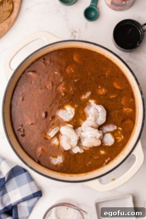 Sausage, okra and shrimp added to gumbo mixture