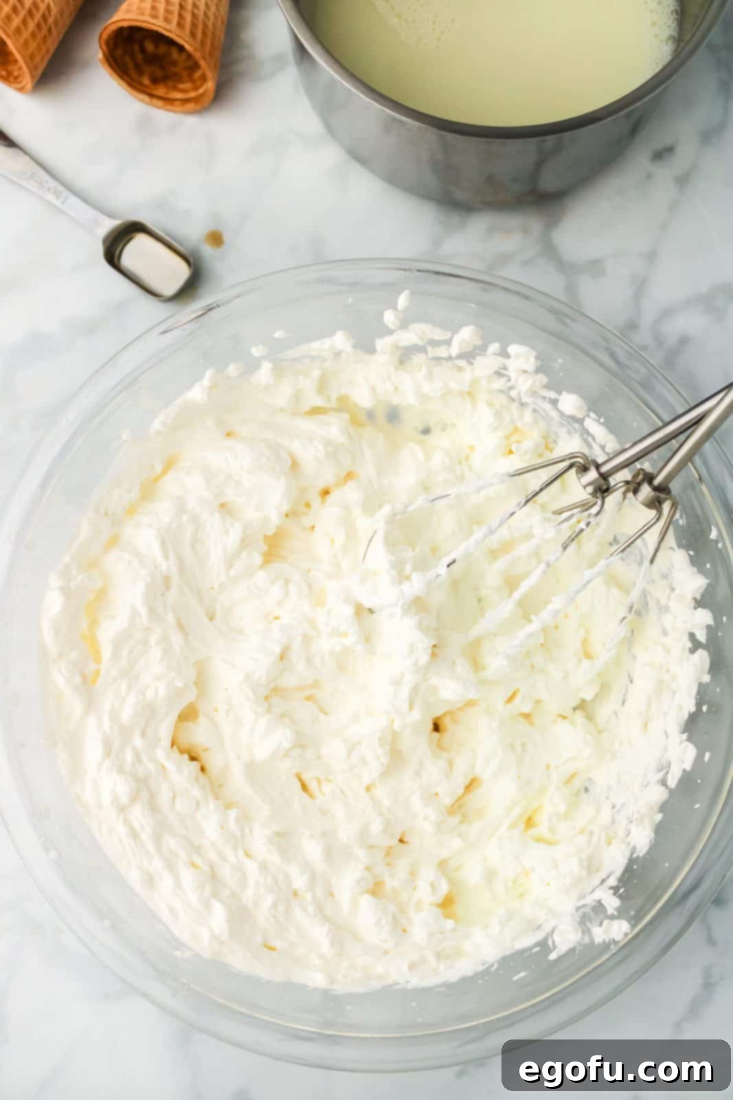 Beaten heavy whipping cream in bowl