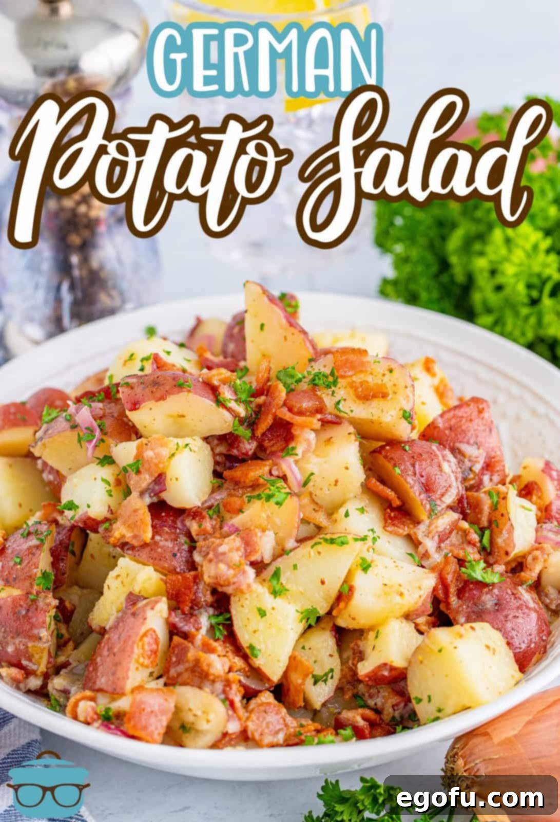 Hearty German Potato Salad 3 Close-up shot of German Potato Salad garnished with fresh parsley in a white bowl, ready to serve.