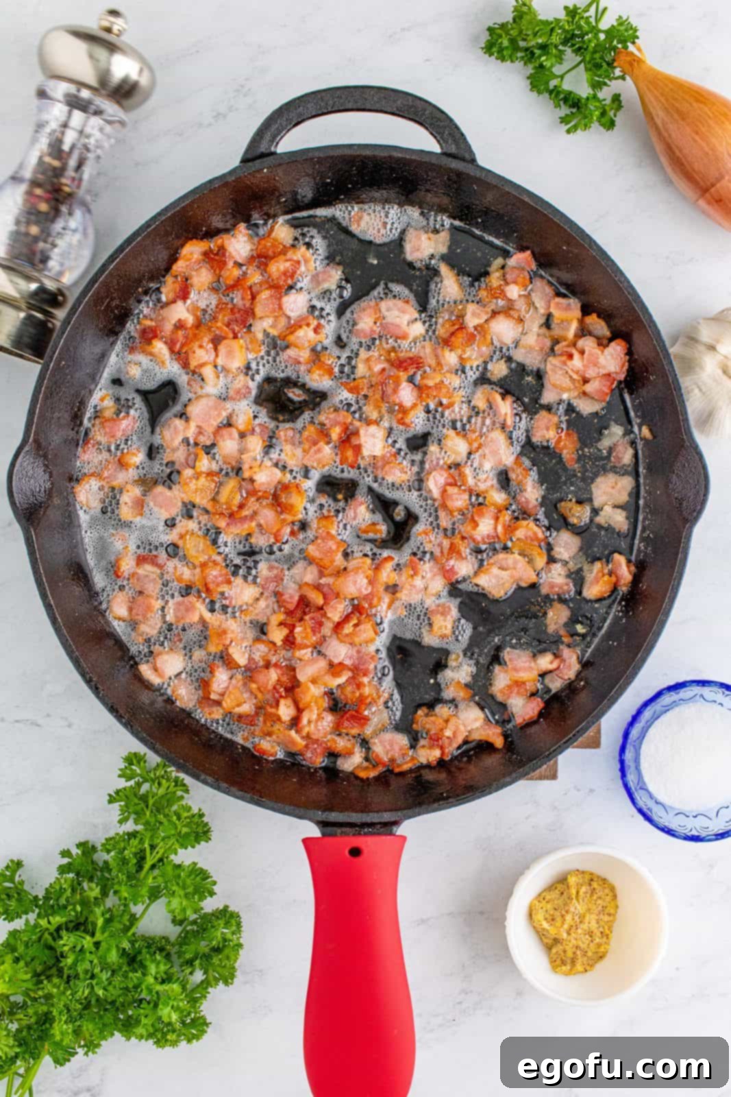 Hearty German Potato Salad 7 Diced bacon sizzling in a skillet, rendering its fat over medium-low heat.