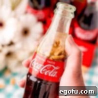 The Classic Cola Crunch 6 Square image of hand holding Coca-Cola and Peanuts