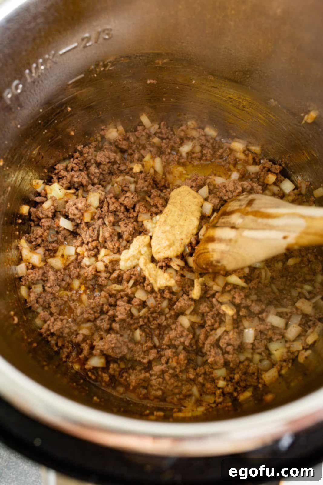 Instant Pot Creamy Beef and Noodle Stroganoff 6 Minced garlic, worcestershire sauce and mustard added to instant pot.