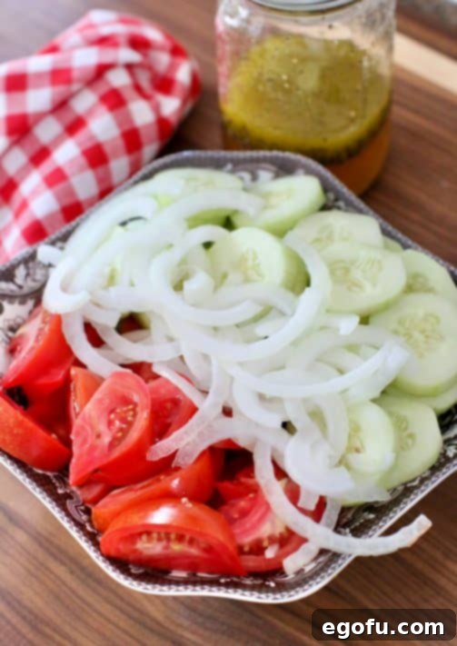 sliced tomatoes, onion and cucumbers in a bowl