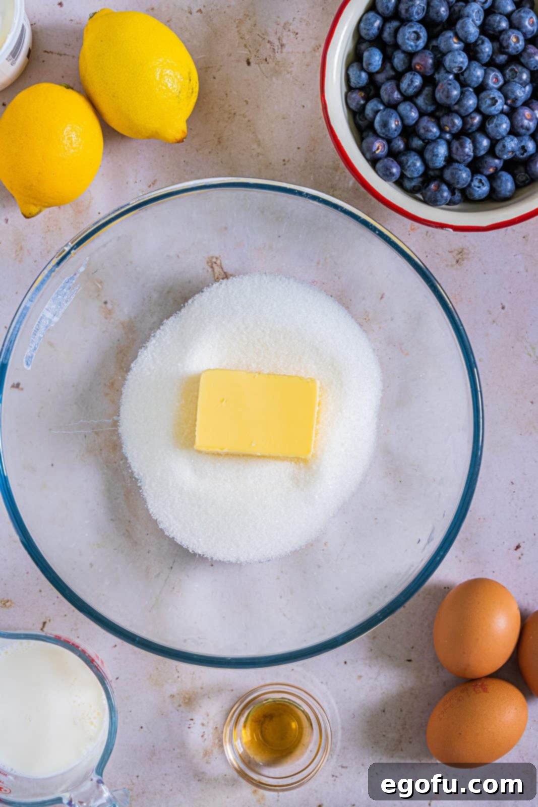 Sugar and butter in a clear bowl.