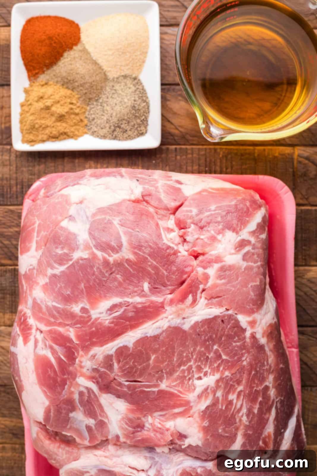 Ingredients needed: pork shoulder, cumin, black pepper, garlic powder, ancho chili powder, celery salt and apple juice. 