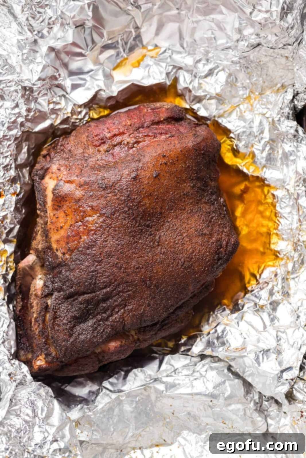 Pork shoulder in foil with apple juice.