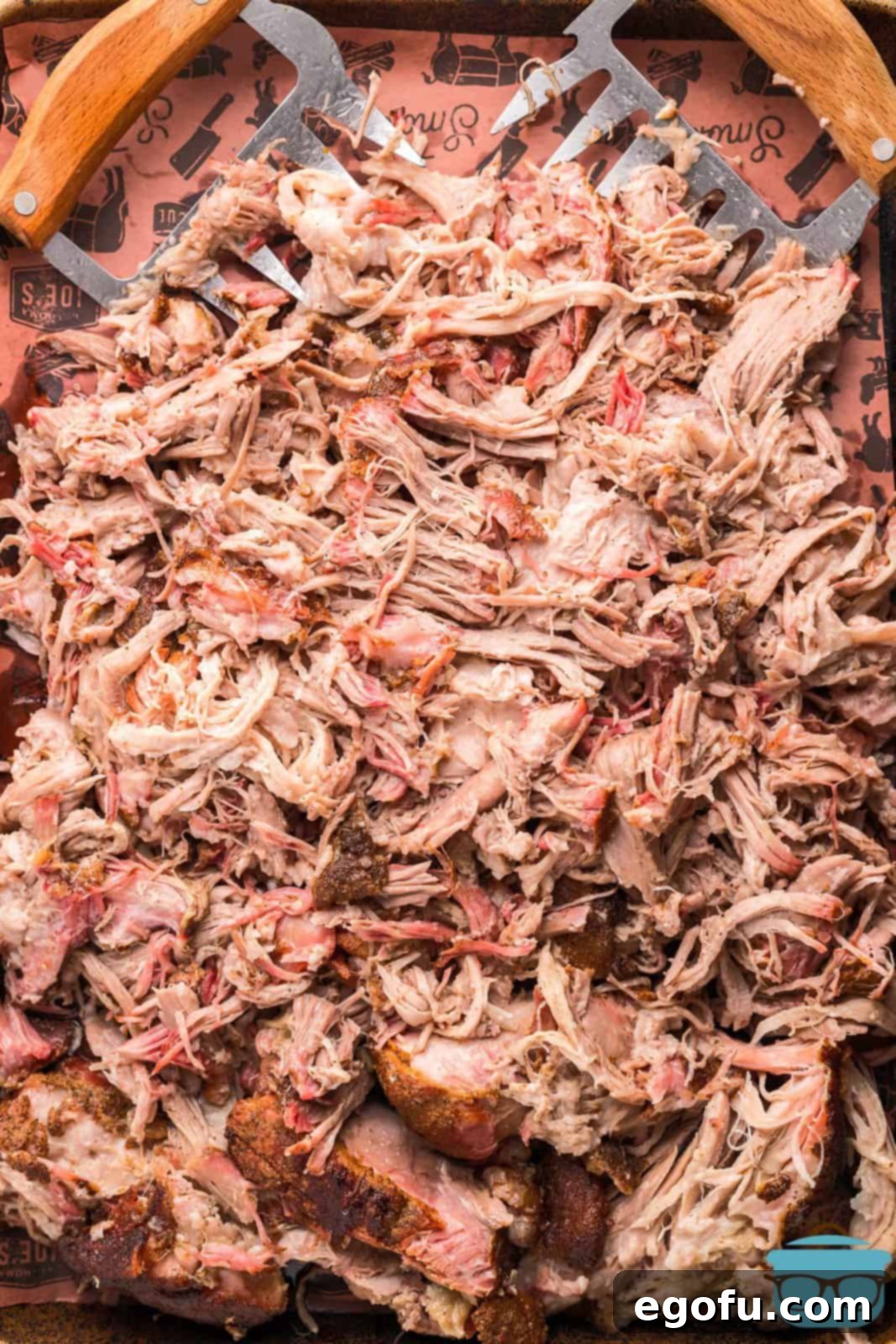 Overhead of shredded Smoked Pulled Pork on tray.