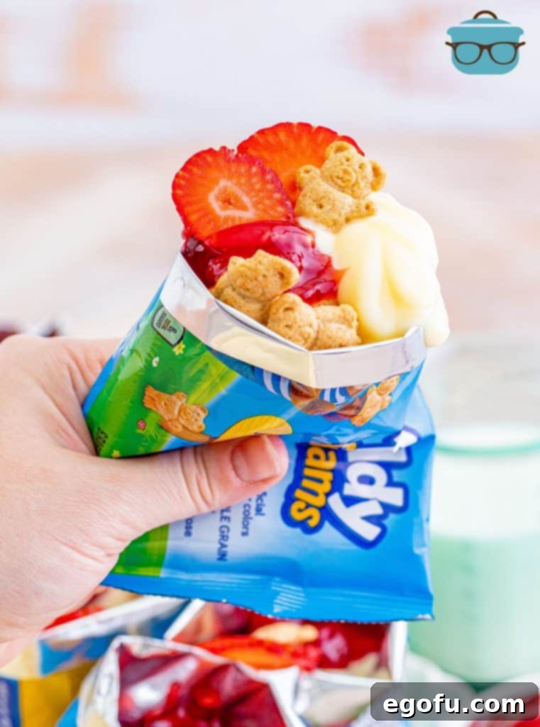 The Wandering Strawberry Cheesecake 2 Hand holding bag of Walking Cheesecake