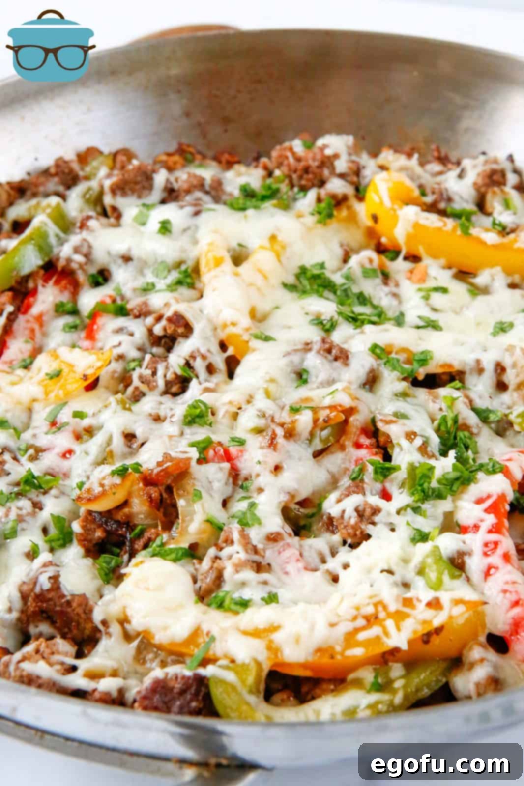 One-Pan Philly Cheesesteak Feast 2 Philly Cheesesteak Skillet in skillet with melted cheese.
