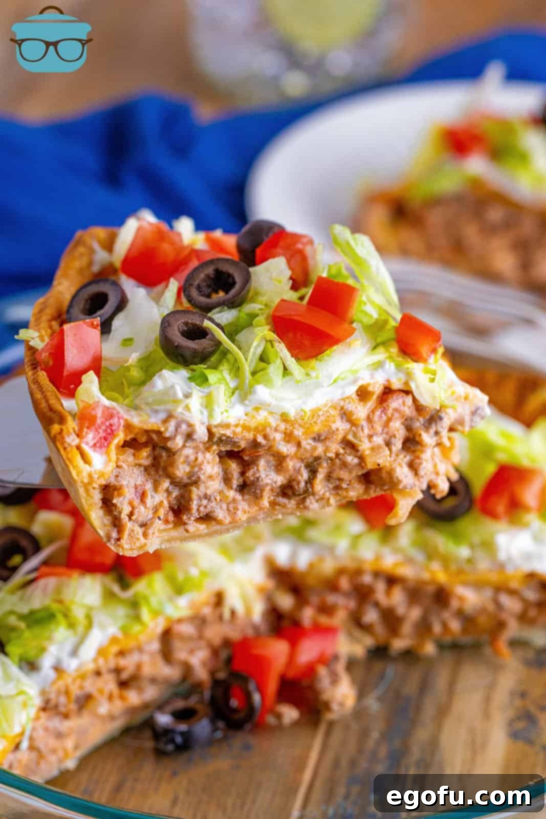 Effortless Taco Bake 2 a pie server holding up a slice of taco pie.