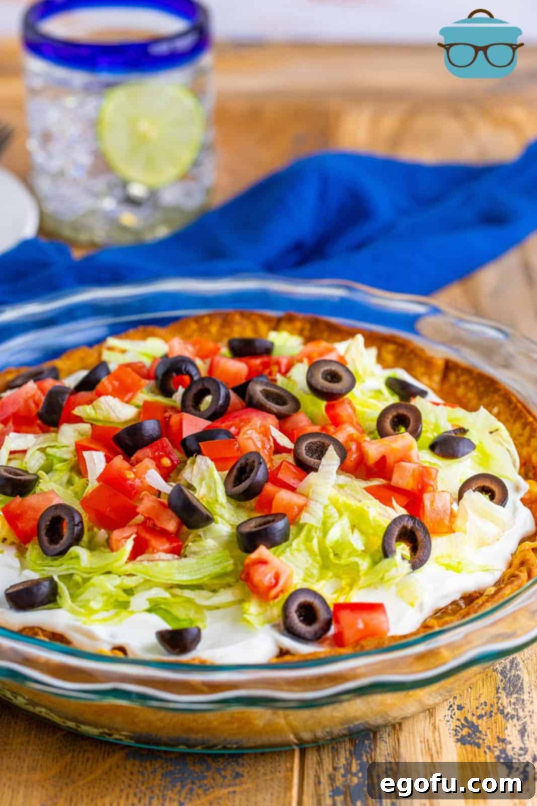 Effortless Taco Bake 13 fully assembled taco pie on a wooden surface.