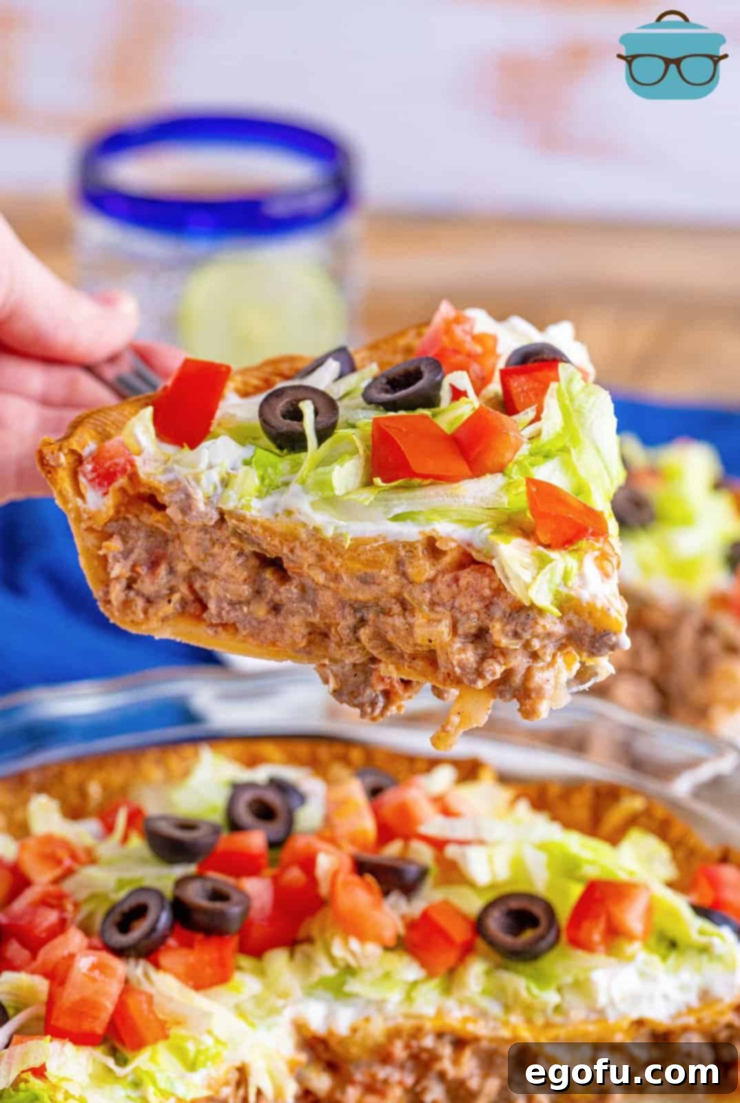 Effortless Taco Bake 14 a closeup photo of a slice of taco pie over a pie pan.