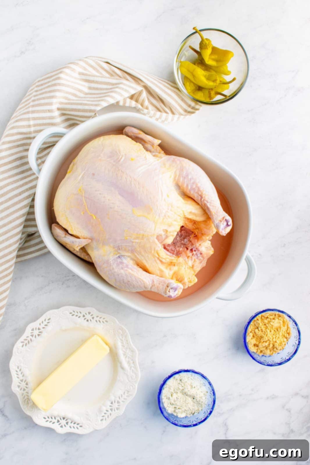 Ingredients needed: whole chicken, chicken gravy mix, ranch dressing mix, unsalted butter, pepperoncini peppers and parsley.