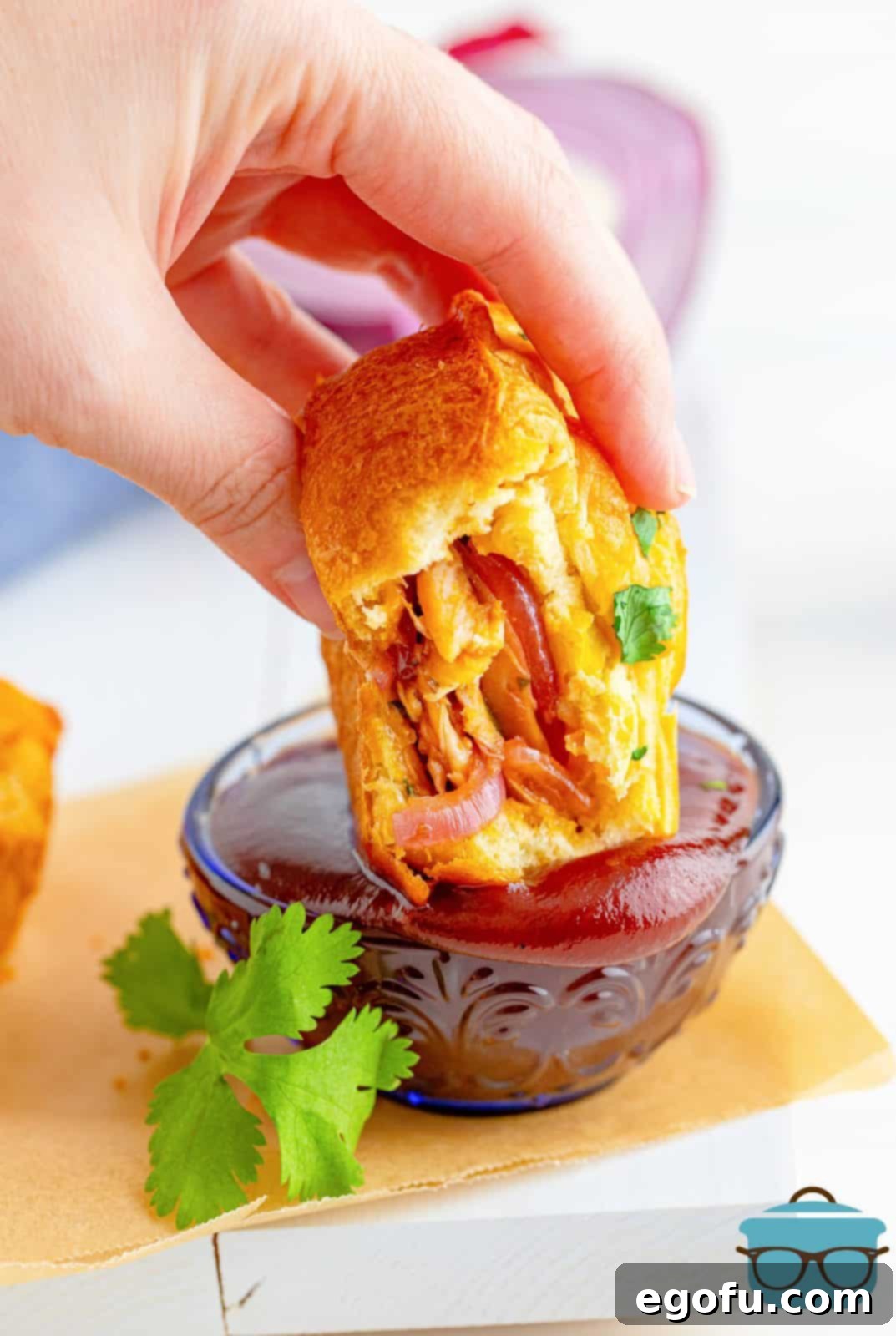 Smoky BBQ Chicken Pizza Bites 2 BBQ Chicken Pizza Cup being dipped into BBQ Sauce.