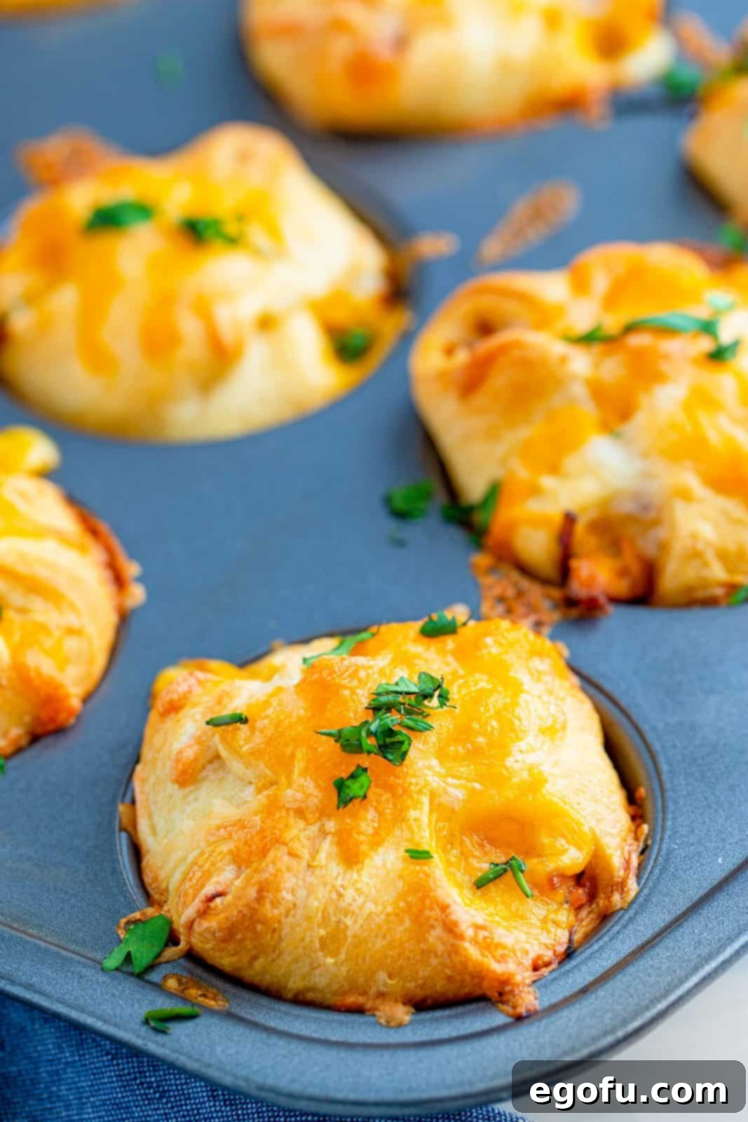 Smoky BBQ Chicken Pizza Bites 14 Baked BBQ Chicken Pizza Cups in a muffin tin, golden brown and bubbly.