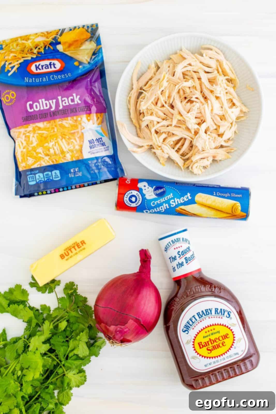 Smoky BBQ Chicken Pizza Bites 4 Ingredients needed: unsalted butter, red onion, shredded chicken, bbq sauce, cilantro, crescent roll dough sheet and colby jack cheese.