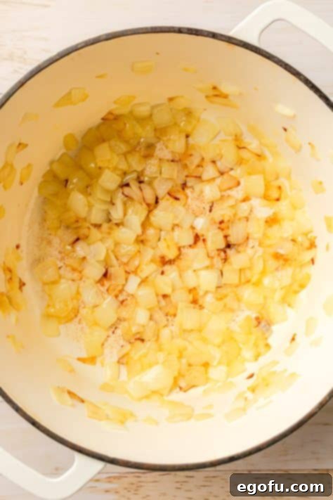 Onions in a pot being cooked.
