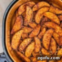 Square image of Air Fryer Potato Wedges in basket.