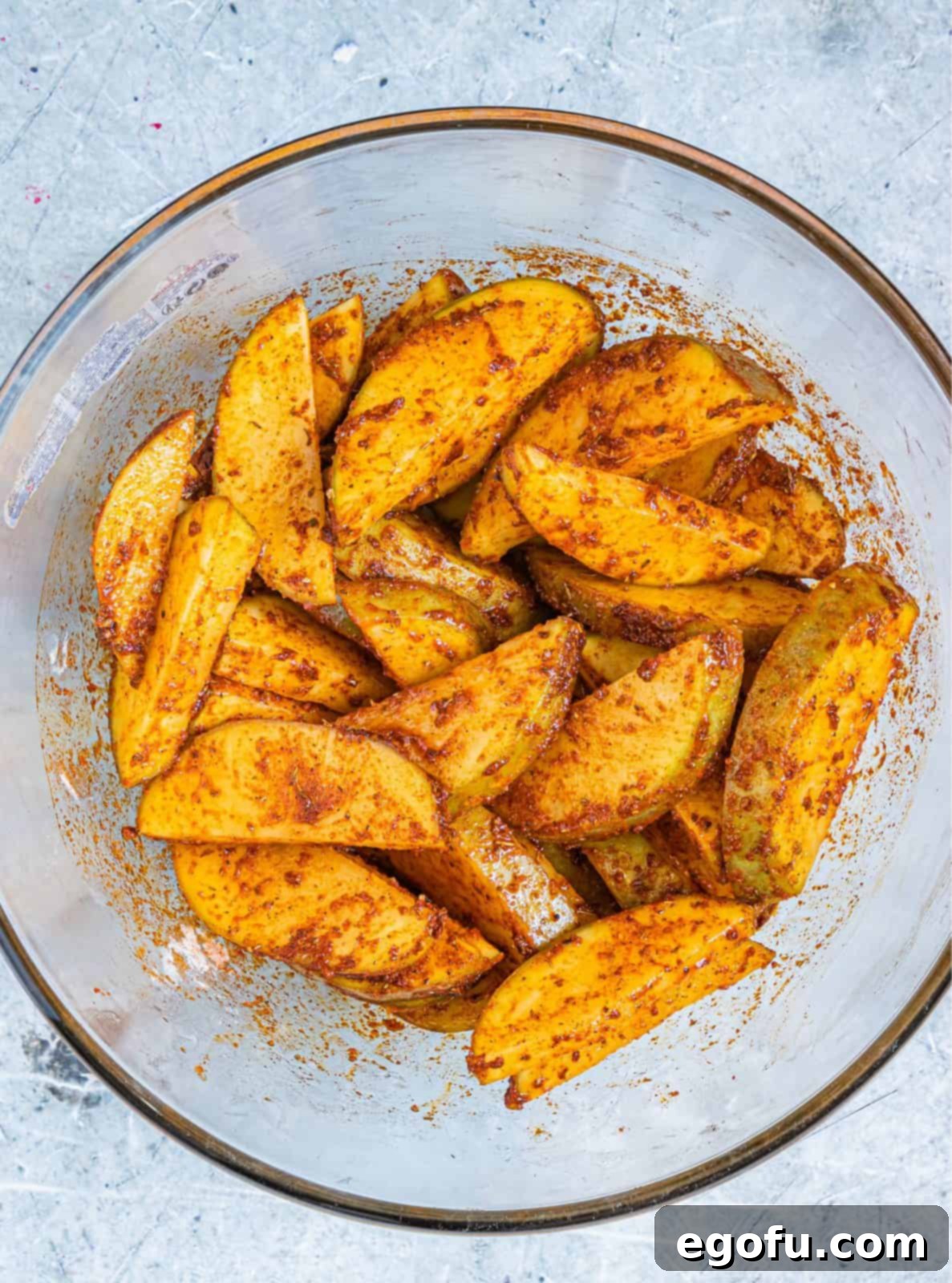 Potato wedges coated in herbs and spices.