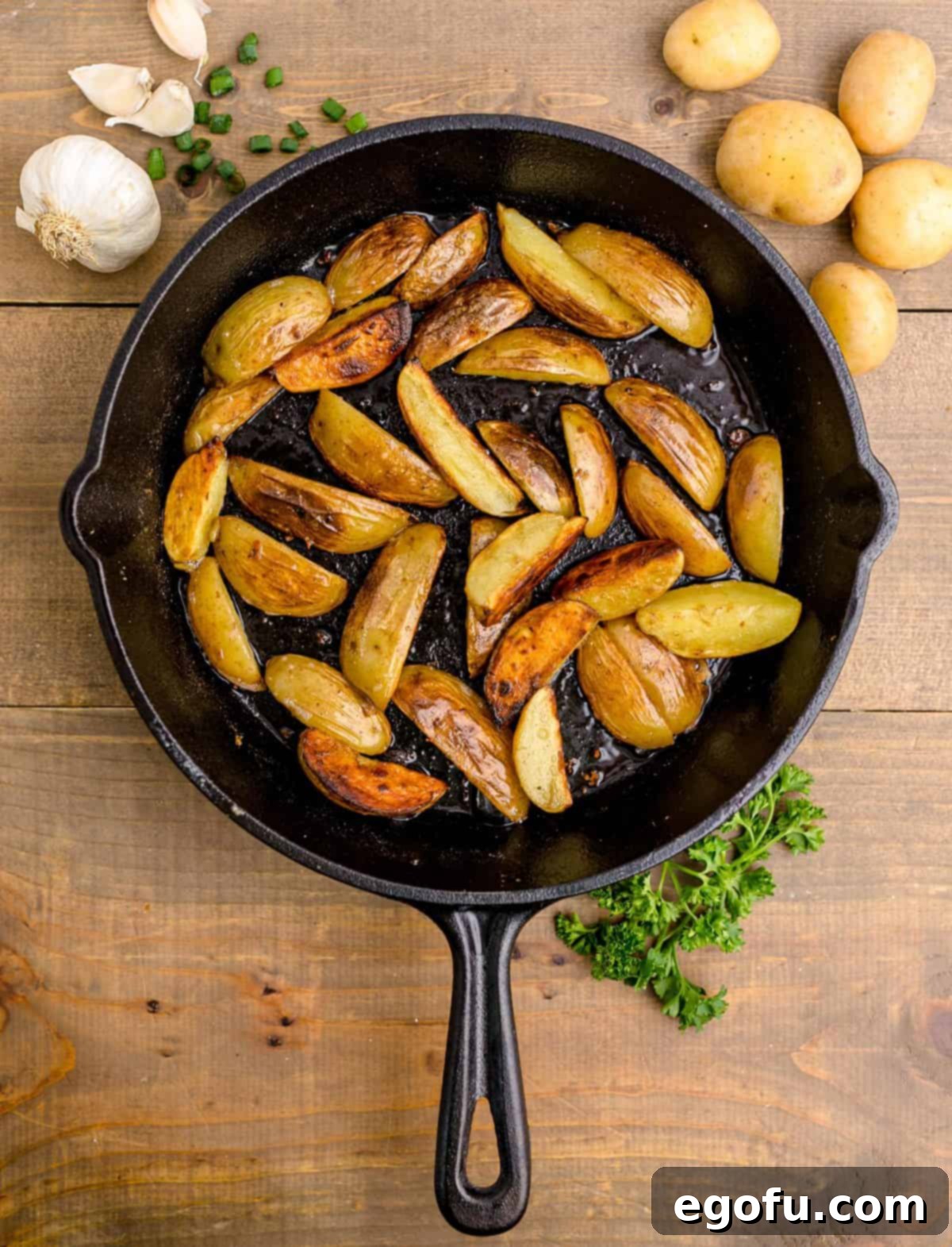 Golden Garlic Butter Chicken and Crispy Potatoes 10 Golden-brown, crispy potatoes sizzling in a cast-iron skillet, freshly fried.