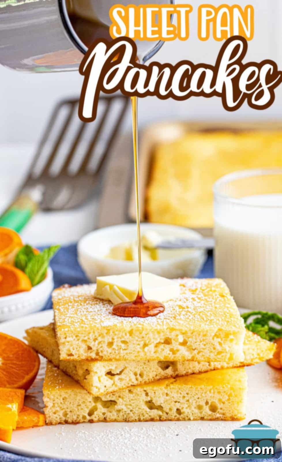 Rich maple syrup being generously poured over freshly baked Sheet Pan Pancakes, highlighting their golden-brown perfection.