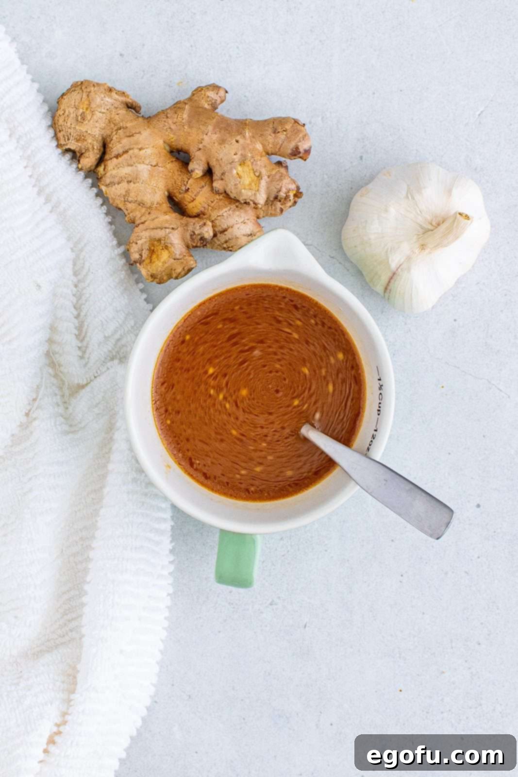 A medium bowl containing chicken stock, brown sugar, soy sauce, hoisin sauce, rice wine vinegar, cornstarch, and sesame oil, all thoroughly whisked together to create the vibrant General Tso's sauce base.