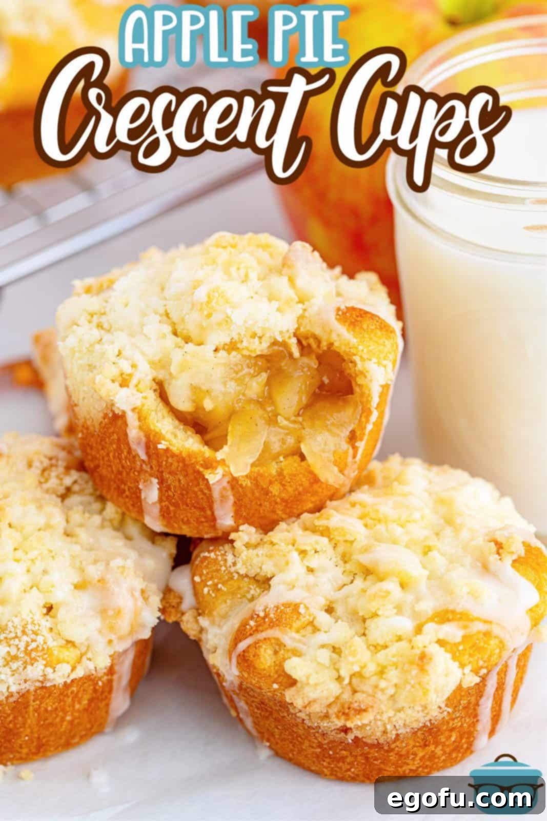 Quick Apple Pie Bites 3 Pinterest image of Easy Apple Pie Cup Recipe stacked and glazed with a bite taken out of one, showcasing the flaky crust.