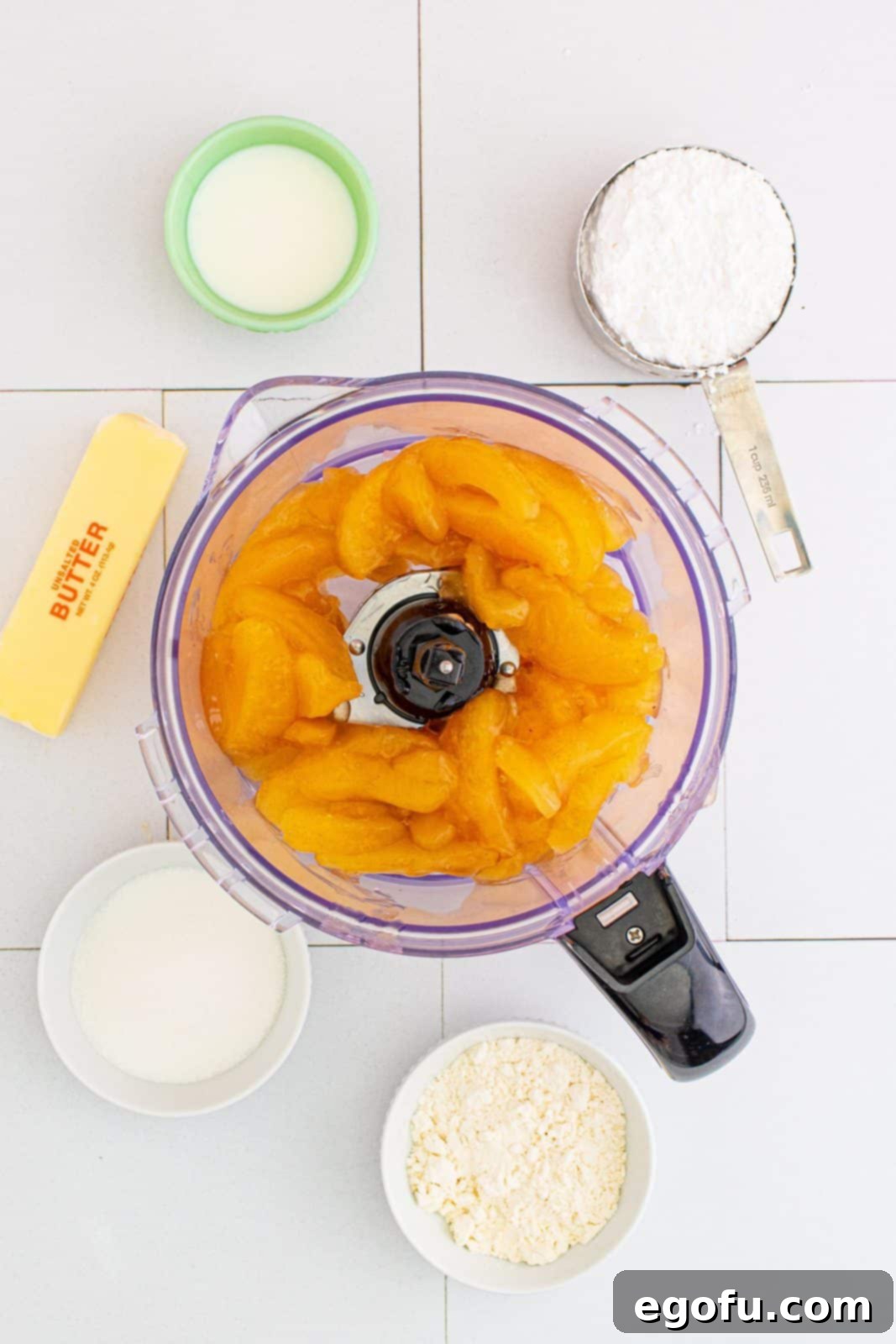 Quick Apple Pie Bites 5 Apple pie filling added to a food processor bowl, ready to be pulsed.