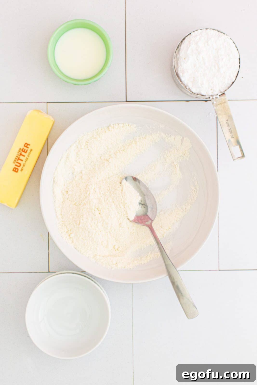 Quick Apple Pie Bites 7 Granulated sugar and all-purpose flour mixed together in a bowl, forming the dry base of the crumble topping.