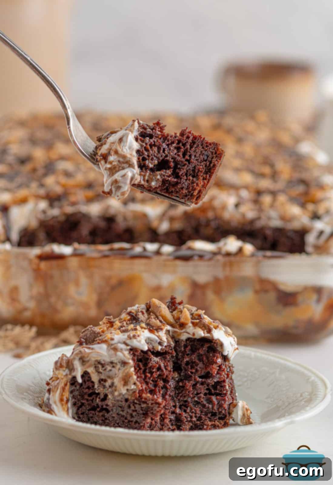 Pure Ecstasy Dessert 2 Fork holding up bite of Better Than Sex Cake.