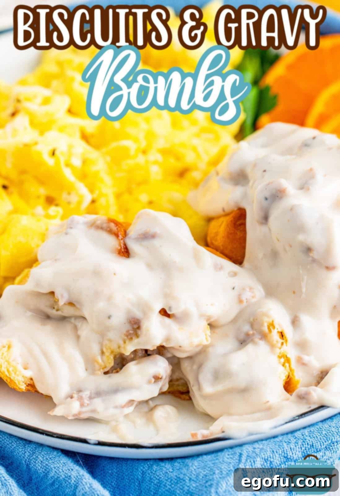 Biscuits and Gravy bombs cut open and shown on a plate with scrambled eggs. 