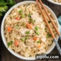 Overhead square image of a bowl of Chicken Pot Pie Ramen with chopsticks resting on top of the bowl.